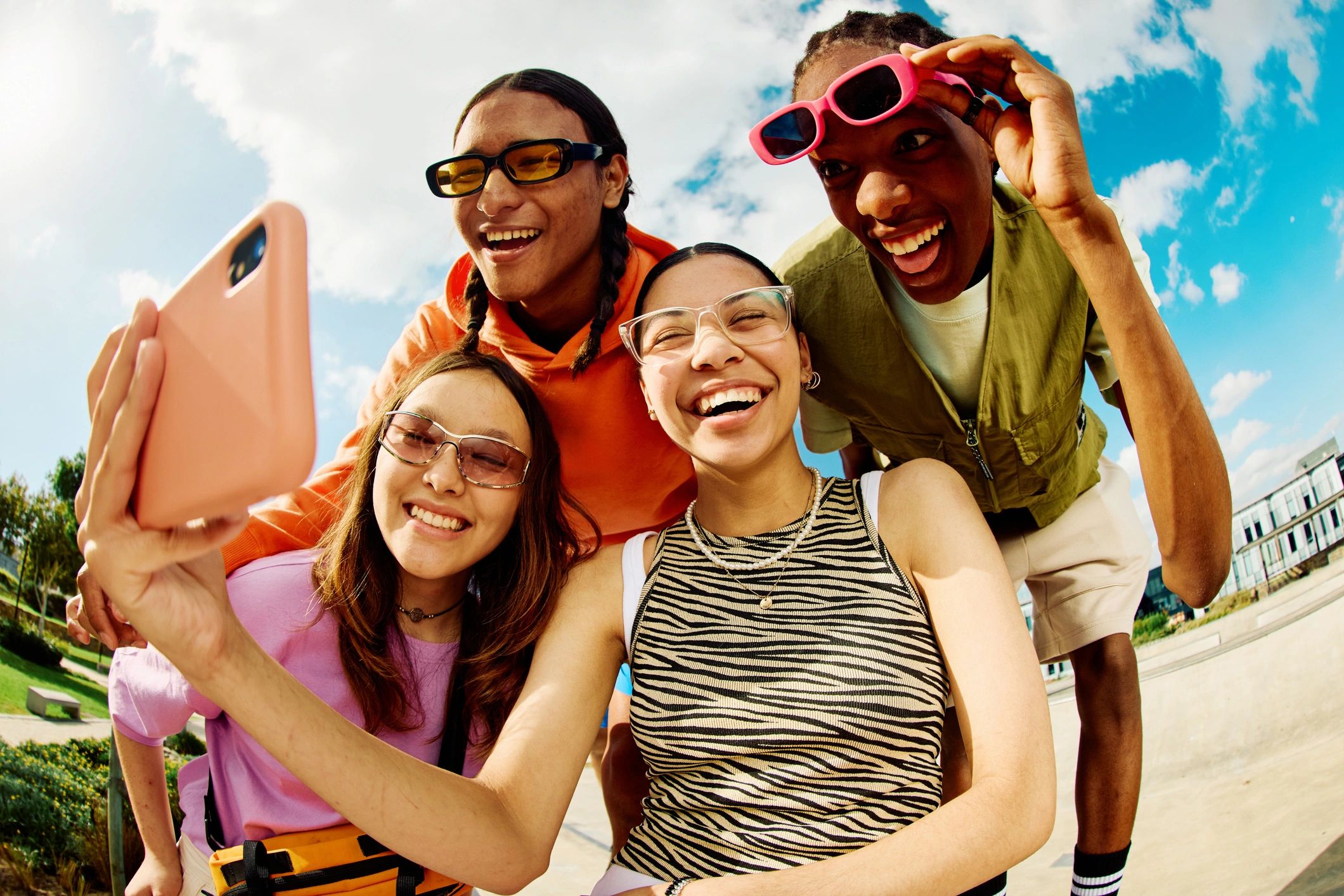 Kids gathered together smiling and looking at a phone