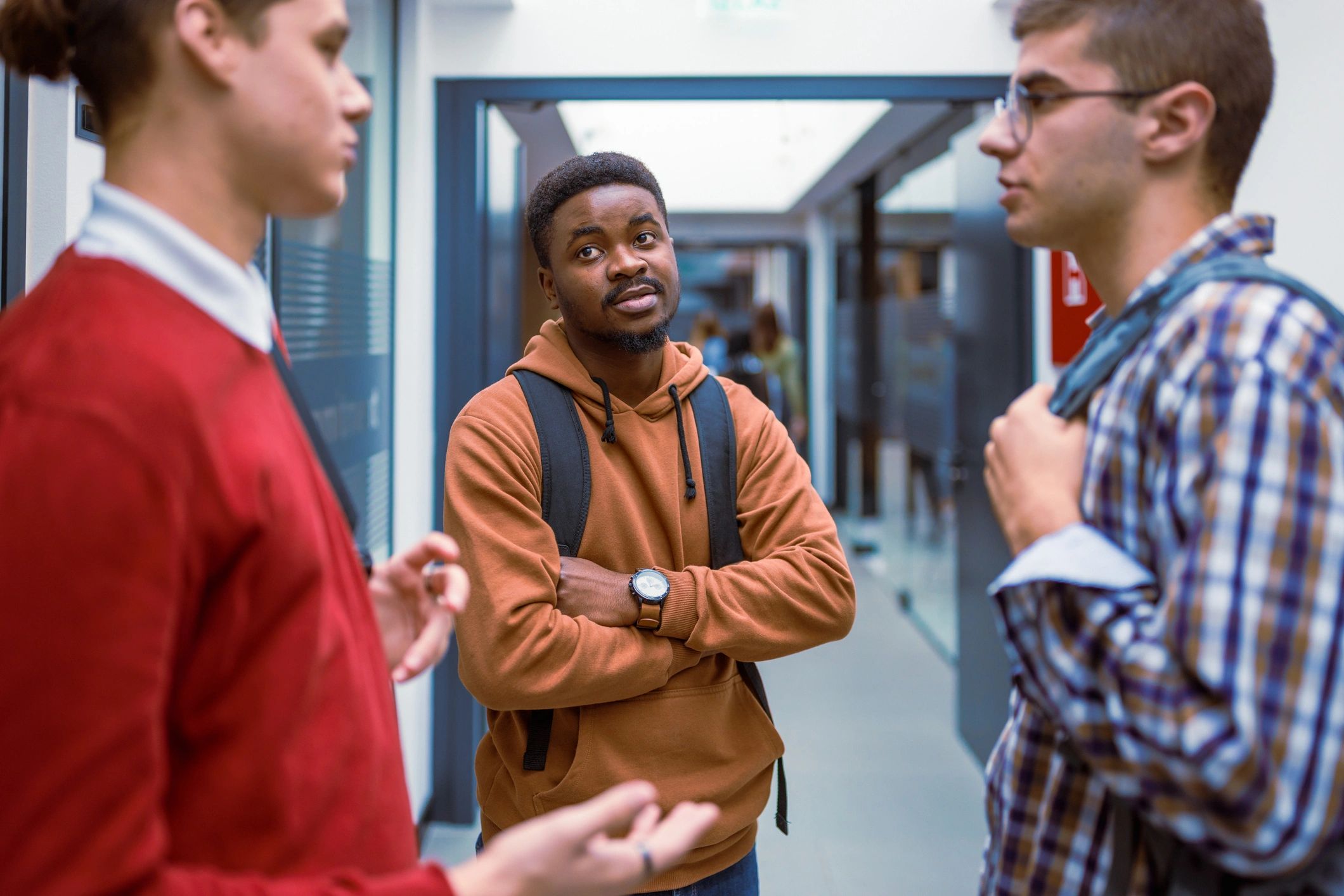 Students in casual outfits in a school hallway